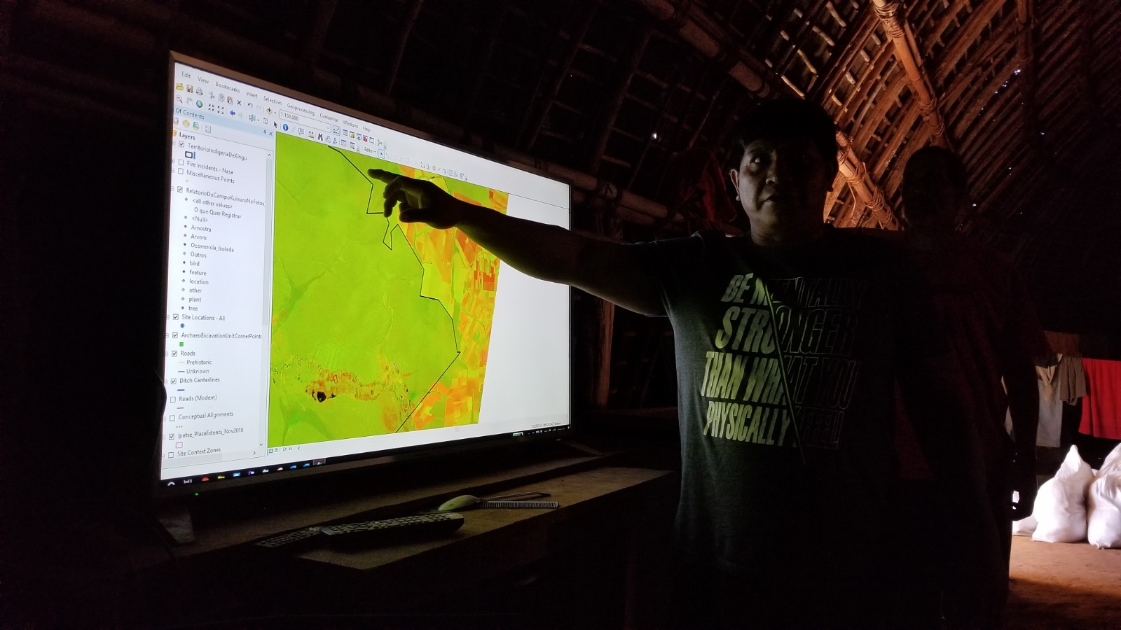 Yanama Kuikuro showing a satellite image of the Xingu territory